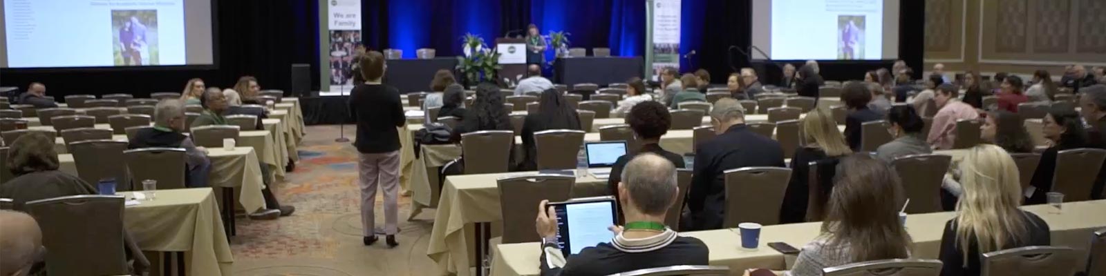 People attend a conference in a large hall